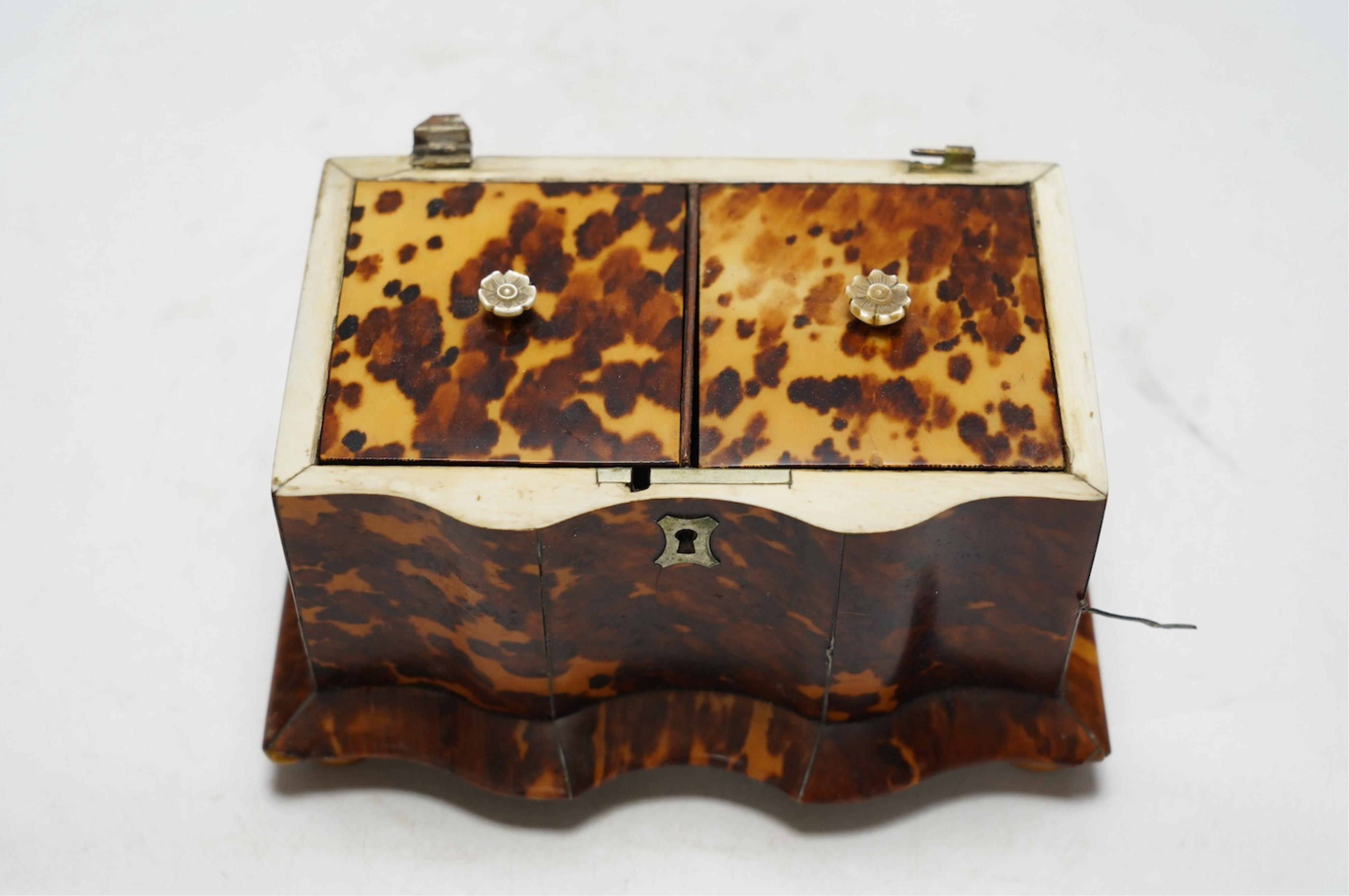 A Regency tortoiseshell tea caddy with inlaid silver and ivory stringing, on later bun feet, 12cm high. CITES Submission reference 64HKMP8J. Condition - poor to fair, lid detached, some repairs needed to stringing